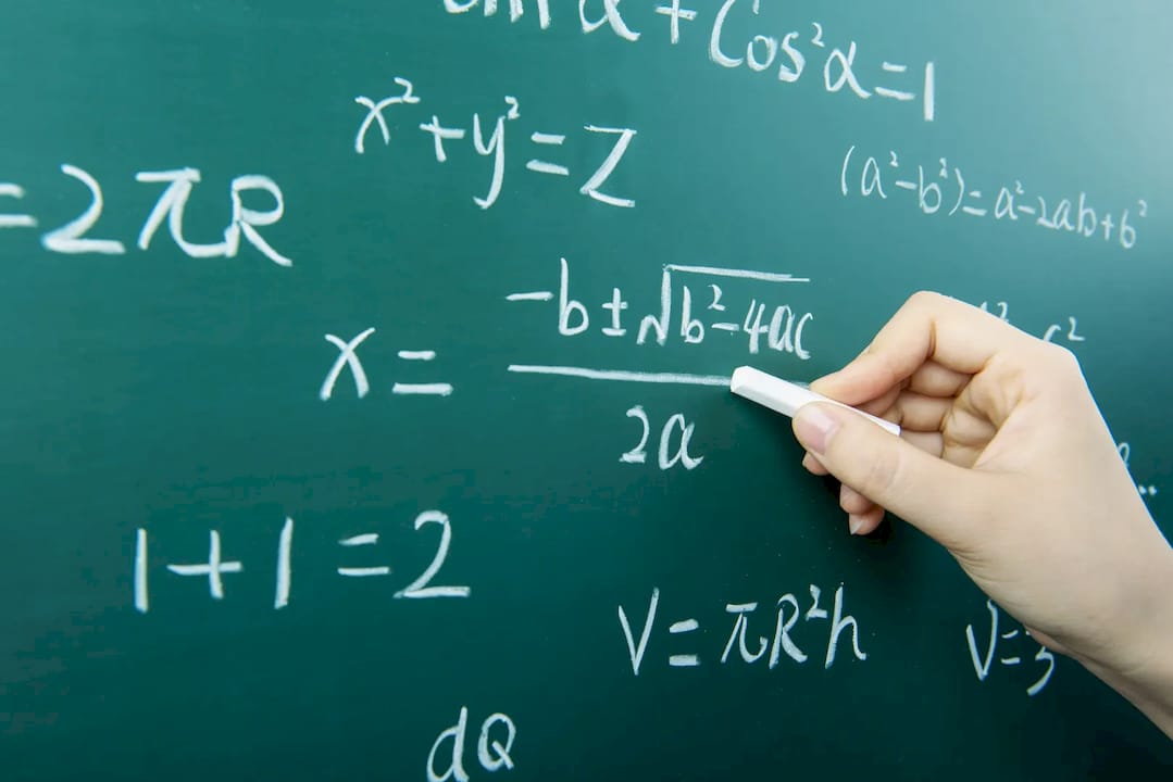 Tutor helping student with math homework at home table