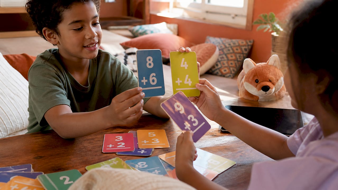 Children playing math fact card game