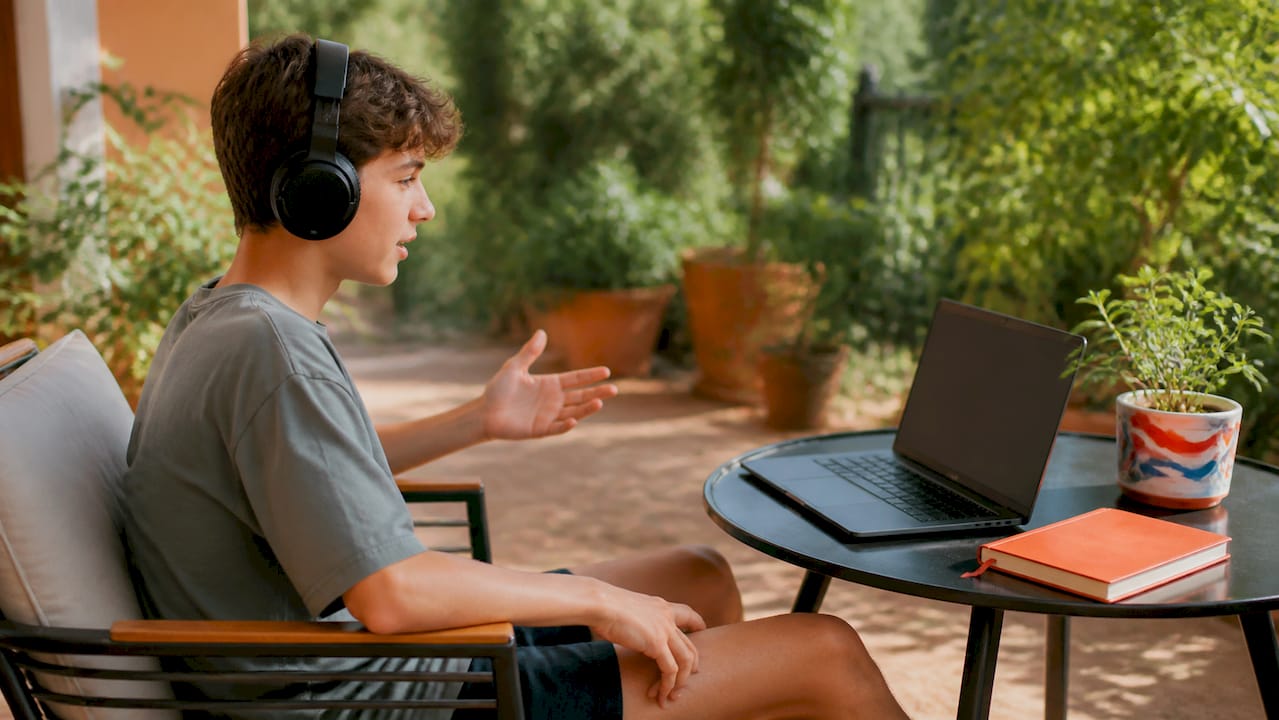Teen practicing shadowing French audio with headphones