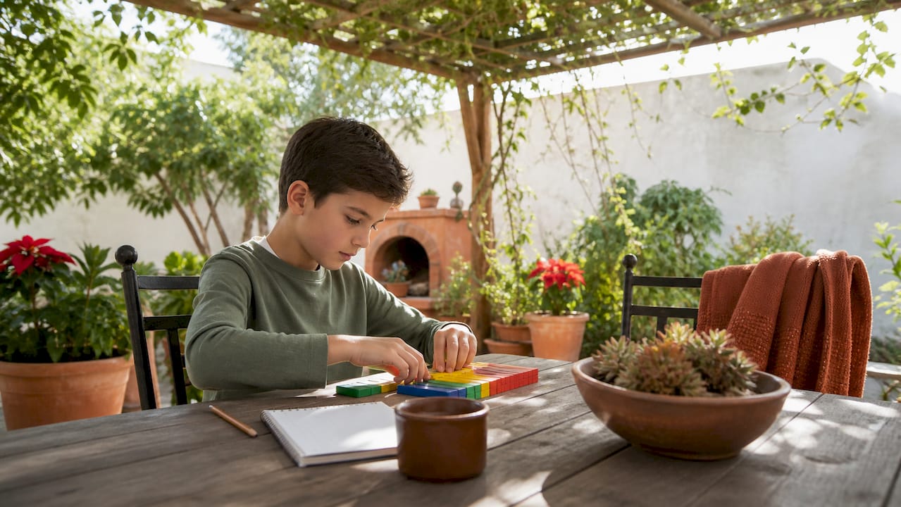 Child calmly working steadily on homework